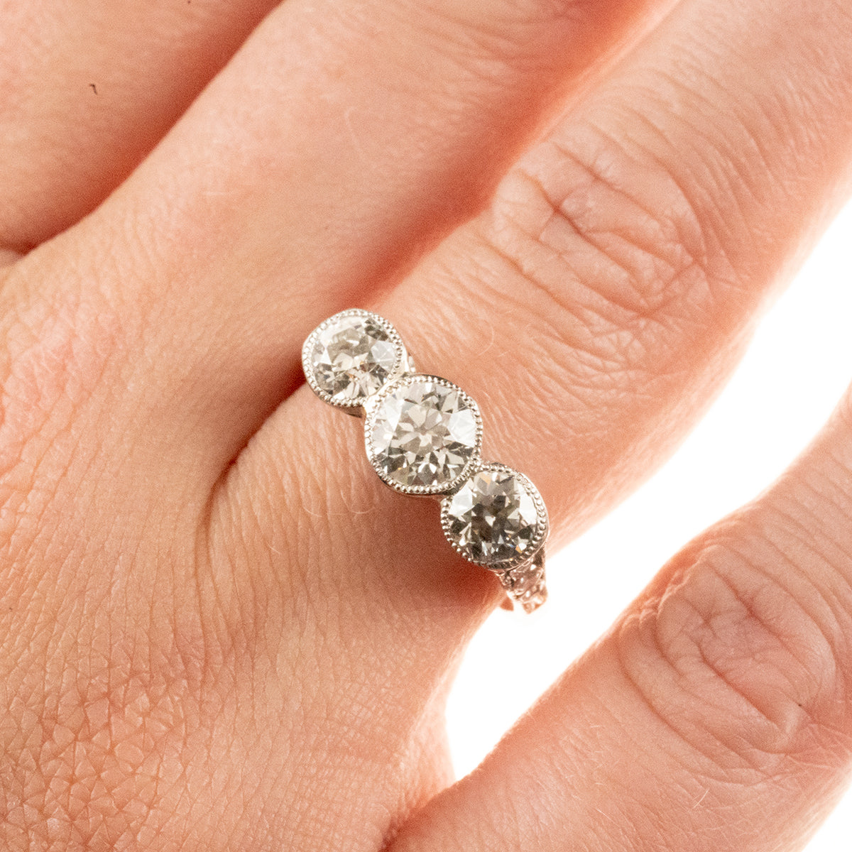 Antique 1920s-era platinum hand-fabricated filigree 3-diamond ring