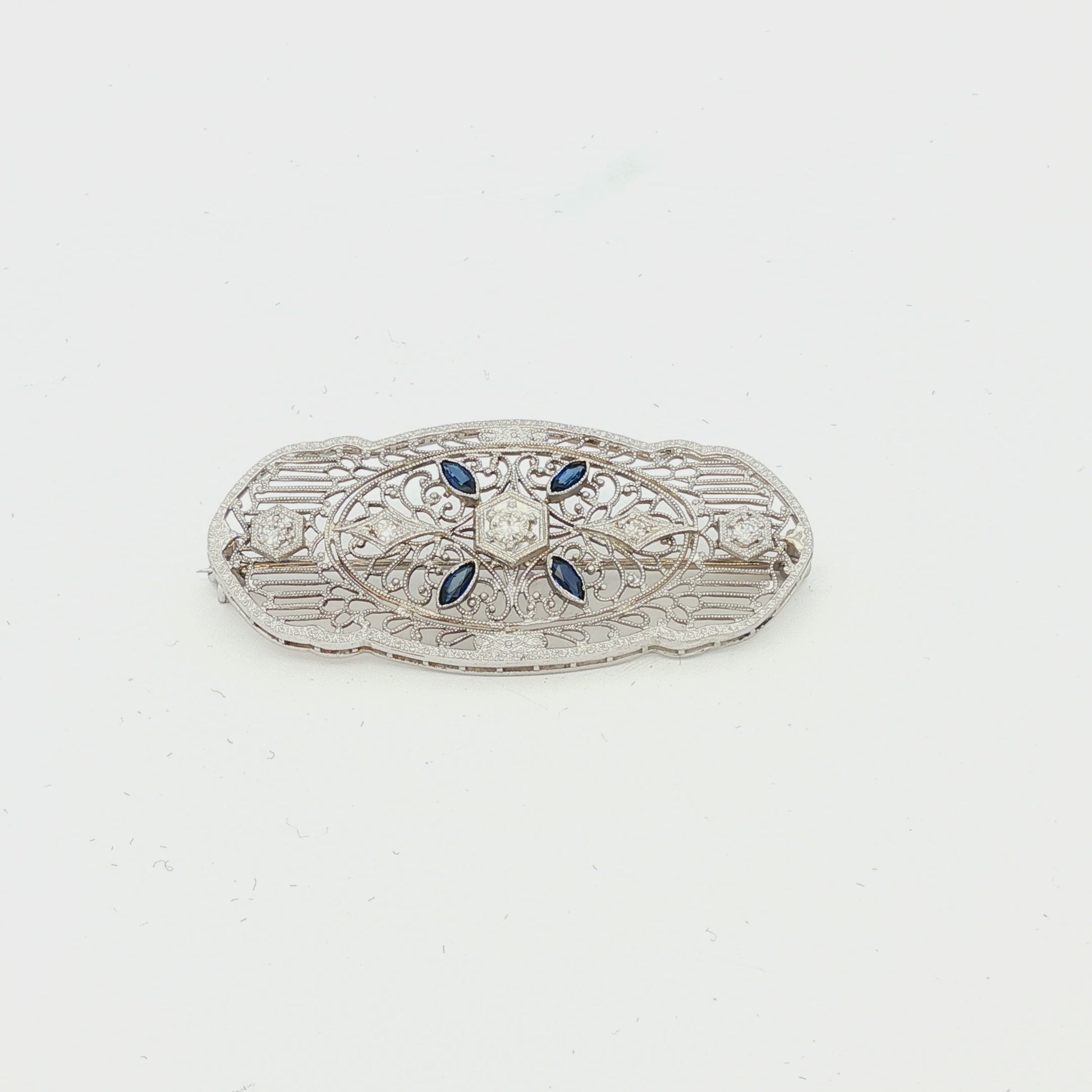 Depression filigree diamond and synthetic sapphire 14k white gold pin